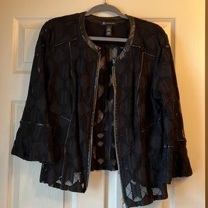Lace looking jacket w/non leather trim. Super cute w/ color shirts underneath